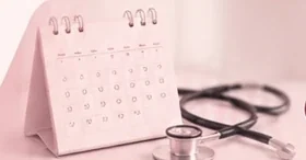 A desk calendar beside a stethoscope.